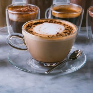 A variety of coffee drinks on a marble table in a Riyadh cafe, perfect for coffee enthusiasts.