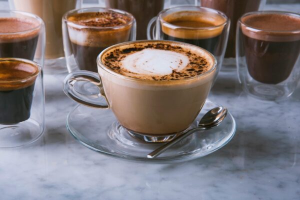 A variety of coffee drinks on a marble table in a Riyadh cafe, perfect for coffee enthusiasts.