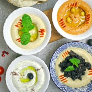 A delicious selection of Middle Eastern dips served in bowls, perfect for healthy eating.