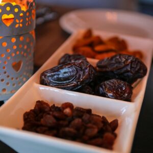 Close-up of dried dates and lantern symbolizing Ramadan traditions. Ideal for festive themes.
