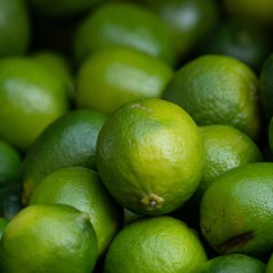 A vivid close-up of fresh limes showcasing their vibrant green hues and textures.