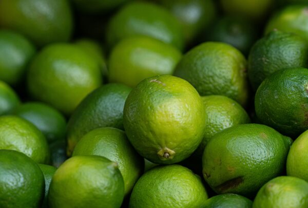 A vivid close-up of fresh limes showcasing their vibrant green hues and textures.