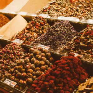 A detailed display of colorful spices, teas, and herbs at a market stall.