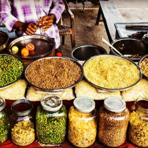 Colorful display of spices and legumes in a traditional Indian street market.